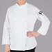 A woman wearing a white Mercer Culinary chef coat.