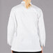A woman wearing a white Mercer Culinary chef jacket with customizable sleeves.