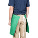 A man wearing a green Intedge waist apron.