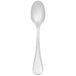 A stainless steel demitasse spoon with a white handle.