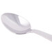 A silver Libbey stainless steel spoon with a white handle.