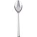 A Libbey stainless steel dessert spoon with a white handle and a silver spoon.