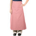 A woman wearing a mauve Intedge bistro apron with 2 pockets.