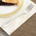 A Libbey stainless steel utility fork on a plate with a piece of pie.