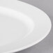 A close up of a 10 Strawberry Street Bistro bright white porcelain oval platter with a curved edge.