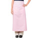 A woman wearing a pink Intedge bistro apron with pockets.