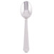 A stainless steel demitasse spoon with a white handle and silver spoon.
