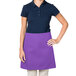 A woman wearing a purple Intedge waist apron.