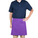 A man wearing a purple Intedge waist apron standing in a professional kitchen.