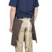 A man wearing a brown Intedge 4-way waist apron.
