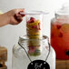 Acopa 2 Gallon Mason Jar Glass Beverage Dispenser with Infusion Chamber, Chalkboard Sign, and Black Stand Main Thumbnail 3