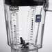 A clear Waring blender jar with a black lid and measuring cup.