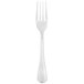 A silver Libbey Geneva dinner fork with a white background.