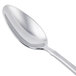 A close-up of a Libbey stainless steel teaspoon with a silver handle.