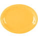 A yellow oval platter with a white border and wavy edges.