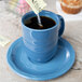 A Libbey blue porcelain saucer with sugar powder on it.