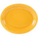 A yellow Libbey oval platter with a wavy design on the edge.