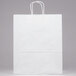 A white paper shopping bag with handles.