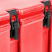 A red Cambro insulated soup carrier with black handles, latches, and hinges.