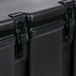 A close-up of a black Cambro insulated soup carrier.