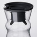 An Arcoroc glass fluid carafe with a black stopper.