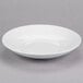 A bright white Tuxton pasta bowl with an embossed rim.
