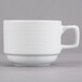 A close-up of a white Tuxton Pacifica china cup with a handle.