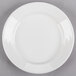 A Tuxton Pacifica bright white china plate with an embossed white rim.