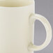 A close-up of a white 10 Strawberry Street porcelain mug with a C-handle.