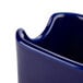 A cobalt blue ceramic sugar packet holder with a white background.