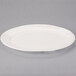 An ivory oval porcelain platter with a rim.