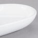An ultra bright white porcelain oval plate with a small rim.