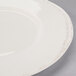A close up of a Libbey Farmhouse ivory porcelain plate with a wide rim.
