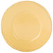 A close-up of a Libbey Farmhouse yellow porcelain plate with a wide rim.