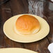 A Libbey Farmhouse porcelain plate with a bun on it and a knife.