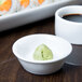 A white Libbey Chef's Selection porcelain ramekin filled with green food.