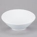 A Libbey white porcelain bowl on a gray surface.