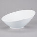 A Libbey white porcelain bowl with a small rim on a gray background.