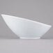 A close-up of a Libbey ultra bright white porcelain Belmar bowl with a curved edge.