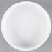 A Libbey ultra bright white porcelain disk bowl on a gray surface.