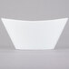 A Libbey Neptune bowl with a curved edge on a white background.