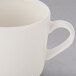 A close up of a Libbey Farmhouse ivory porcelain cup with a white handle.