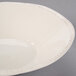 A Libbey ivory porcelain bowl with a white rim on a white background.