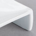 A close up of a Libbey ultra bright white porcelain square plate with a curved edge.