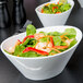 A Libbey white porcelain bowl filled with a salad of shrimp and vegetables.