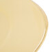 A close-up of a Libbey Farmhouse yellow porcelain plate with a wide rim.