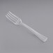 A Visions clear plastic tasting fork on a gray background.