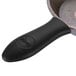 A black Lodge pan with a Lodge black silicone handle holder on the handle.