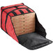 A red ServIt insulated pizza delivery bag holding several pizza boxes.