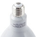 A Satco frosted white LED flood light bulb shining white light.